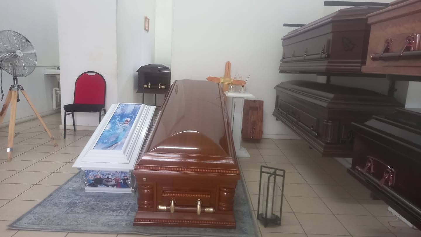 A selection of polished coffins and caskets in the Ibanokuthula showroom